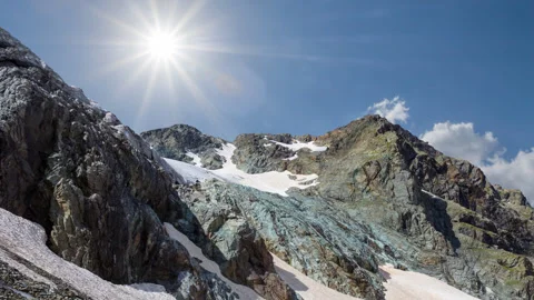 Green mountain chain in snow under blue cloudy sky Stock-Footage 248036152