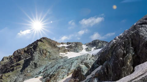 Green mountain chain in snow under blue cloudy sky Stock-Footage 331998083