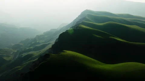 The green mountain hills are backlit. Screensaver as in the picture from the Stock Footage 257515403