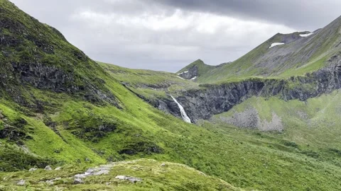 Green mountain landscape with distant waterfall an Stock Footage 338355833
