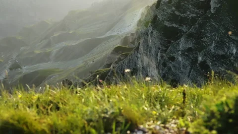 A green mountain range with a valley in the background. A grass on a mountain Stock Footage 256772719