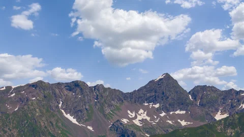 Green mountain ridge  under cumulus clouds time lapse scene Stock Footage 247169986