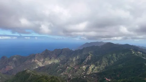 Green Mountain Ridges Overlooking the Ocean from Above Stock Footage 345576406