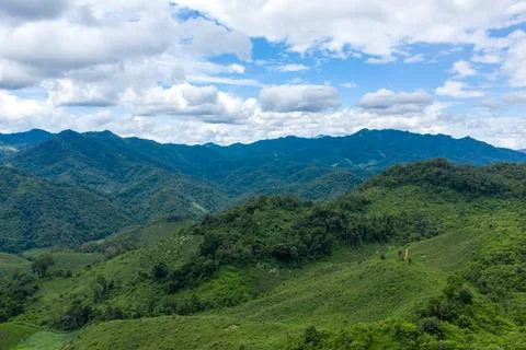 Green mountain ridges under cloudy sky Laos Stock Photos