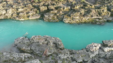 Green mountain river flowing through desolate rocky landscape. Stream bed cut Stock Footage 232976834