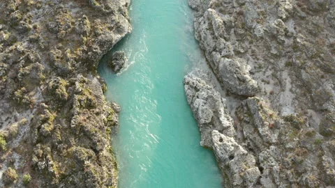 Green mountain river flowing through desolate rocky landscape. Stream bed cut Stock Footage 232980255