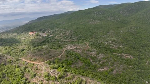 Green Mountain Slope and Winding Dirt Roads in Greece Stock Footage 336563992