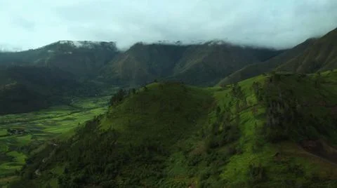 The green mountain is surrounded by clouds Stock Photos