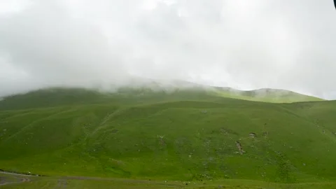 Green mountain terraces contrast grass and leaden clouds Stock Footage 342713237
