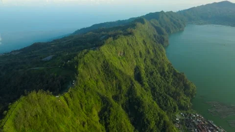 Green mountain with trees under cloudy sky seen from above Stock Footage 315402284