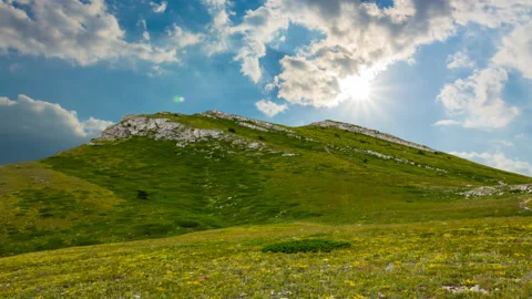 Green mountain under cloudy sky at the sunny day time lapse scene Stock Footage 201129391