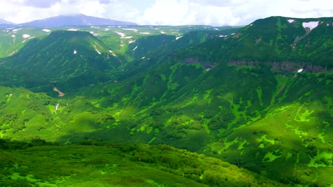 Green mountain valley landscape with moving cloud shadows Stock Footage 337030351
