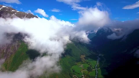 Green mountain valley with a river beneath flowing clouds Stock-Footage 341328931
