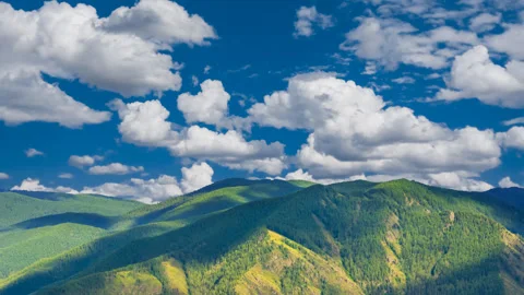Green mountain valley under blue cloudy sky Stock Footage 326832336