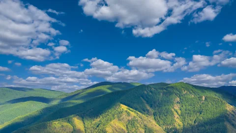 Green mountain valley under blue cloudy sky Stock Footage 342102598