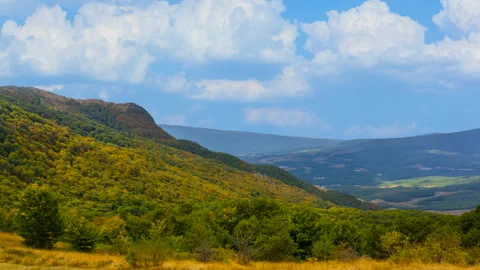 Green mountain valley under a dense cloudy sky time lapse scene Stock Footage 250155370