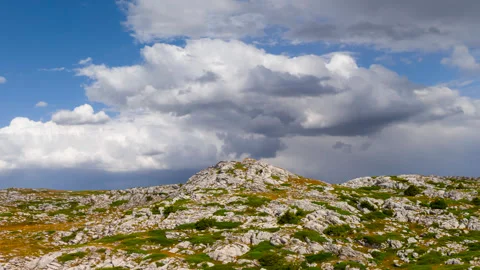 Green mountain valley under dramatic cloudy sky Stock Footage 319737455