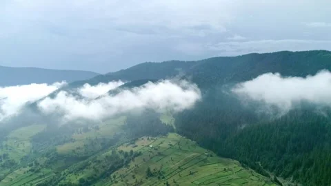 Green mountain valley with white clouds above Stock Footage 322061632