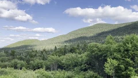 Green mountains and blue cloudy sky Stock Footage 284875769