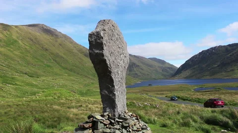 Green Mountains and Grass Fields with Gravestone in Ireland Wide Stock Footage 67548156