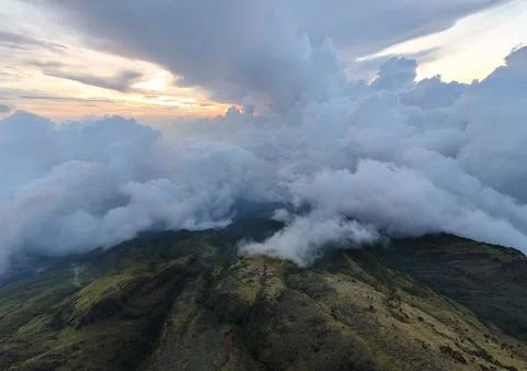 Green mountains with cloudscape cover under morning sky. Stock Photos