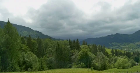 Green mountains. Cloudy sky and hills meadow. Panning. Forest in the mountains Stock Footage 77278162
