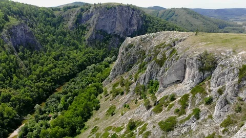 Green mountains. The copter is down on the rocks. Stock Footage 129510060