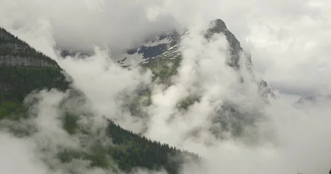 Green mountains covered with white clouds Stock Footage 97607806
