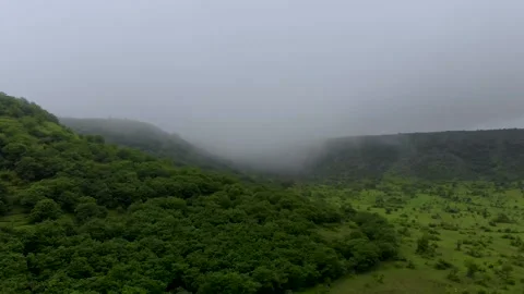 Green mountains with foggy weather at hill side drone shot Stock Footage