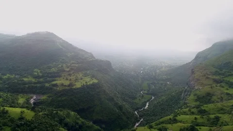Green mountains with river passing through them Stock Footage 106351584