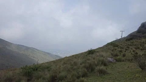 Green Mountainside Overlooking Valley with Pylon, Cruz Loma, Quito, Ecuador 8K Video stock 331494483