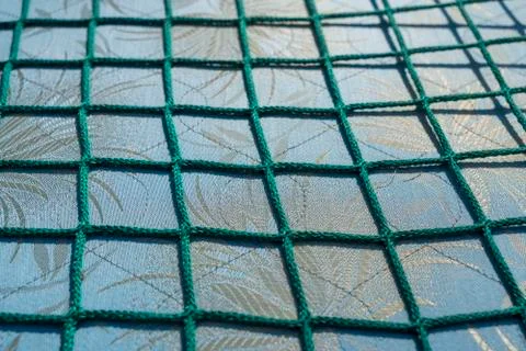 Green net over a fabric pattern for backgrounds Stock Photos