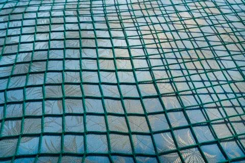 Green net over a fabric pattern for backgrounds Stock Photos