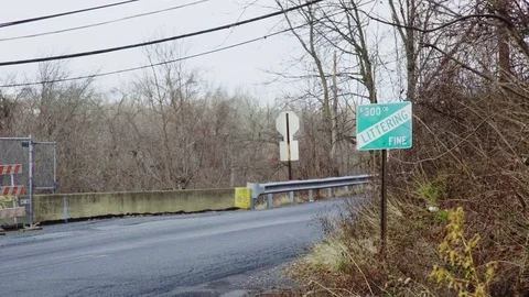 Green no littering sign on the side of the road Stock Footage 72321973