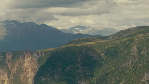 Green Norwegian Highlands and Distant Snow Patches under Moody Sky Stock Footage 340323748