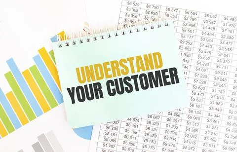 Green notepad on financial documentation. Text UNDERSTAND YOUR CUSTOMER. Busi Stock Photos