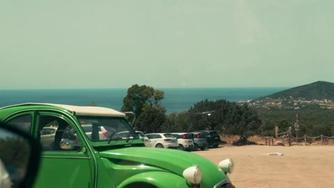Green old timer foreground, hills and sea in the background Stock Footage 229192600