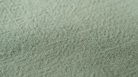 Green olive fabric close-up, light khaki cloth texture background. Macro Stock Footage 168693973