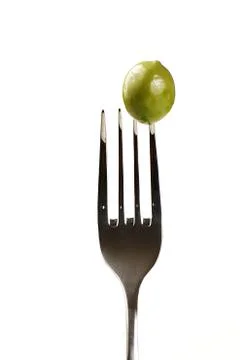 Green olive on a fork Stock Photos