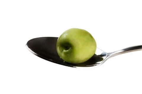 Green olive on a spoon Foto stock