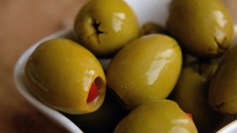 Green Olives Stuffed with Red Bell Peppers rotating, close up. Macro Vídeos de archivo 125355144