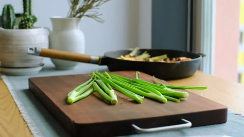 Green onion falling in front of the camera. Fresh organic spring onion for Stock Footage 245257983