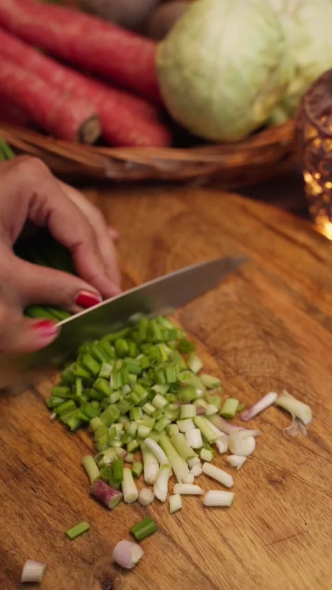 Green onion or hare piyaz chopping on wooden chopping board, cutting green onion Stock Footage 283362953