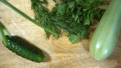 Green onions falling in slow motion on vegetables. Stock Footage 138981599