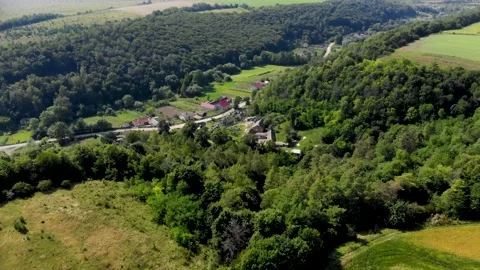 Green, orange and light brown field, forest and blue sky. Summer. Village. Stock Footage 138929545