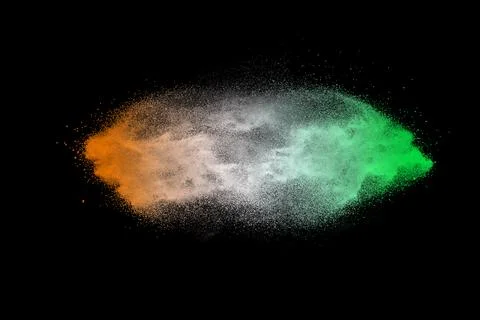 Green orange dust particles explosion on black background. Color powder dus.. Stock Illustration