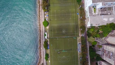 Green outdoor fields of Stanley Ho Sports Centre, Sandy Bay, aerial shot Stock Footage 75865940