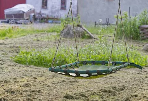 Green Outdoor Swing in Rustic Backyard Stock Photos