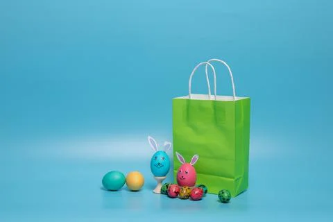 Green package and easter eggs on a blue background Stock Photos