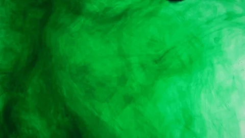 Green paint dissolves in clear water. Slow motion Stock Footage 81577464